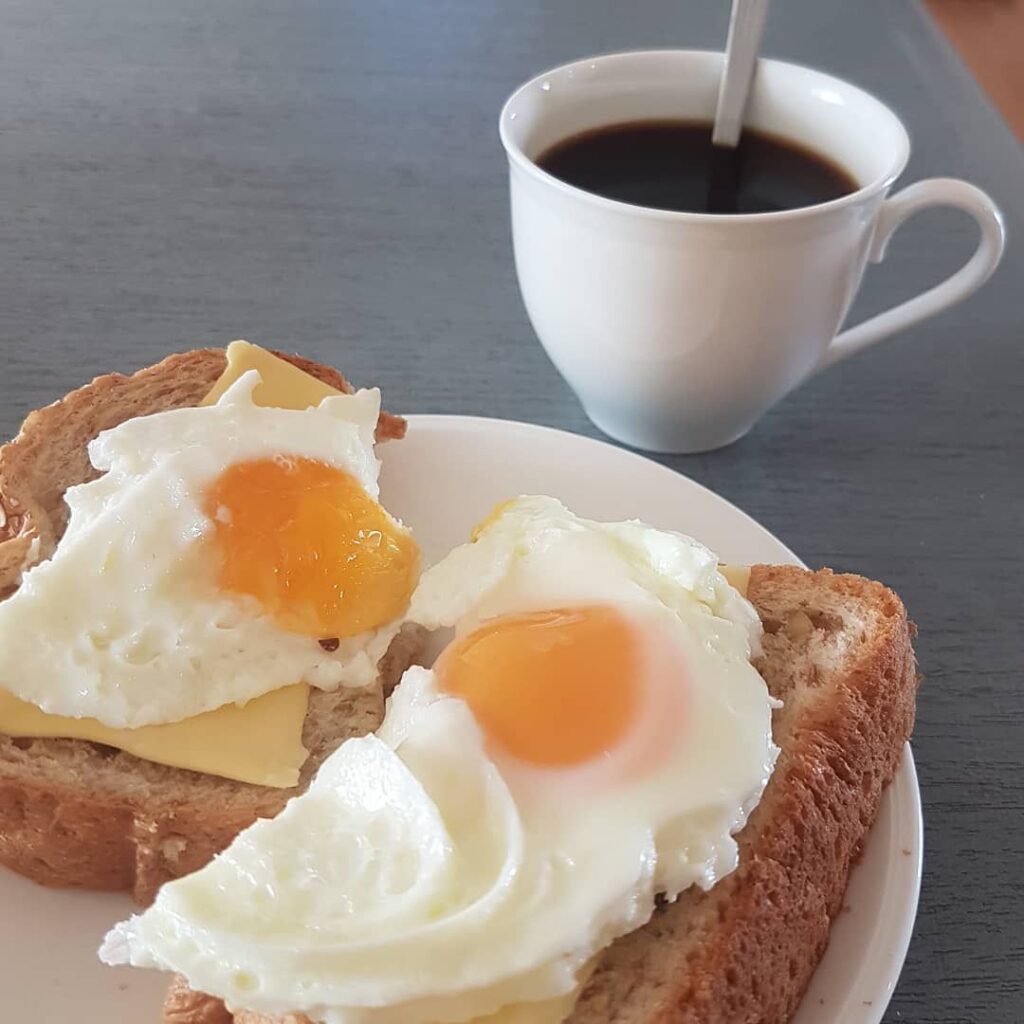 Two eggs with toast and coffee